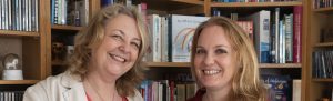 Ladey and Abbirose in front of a bookcase